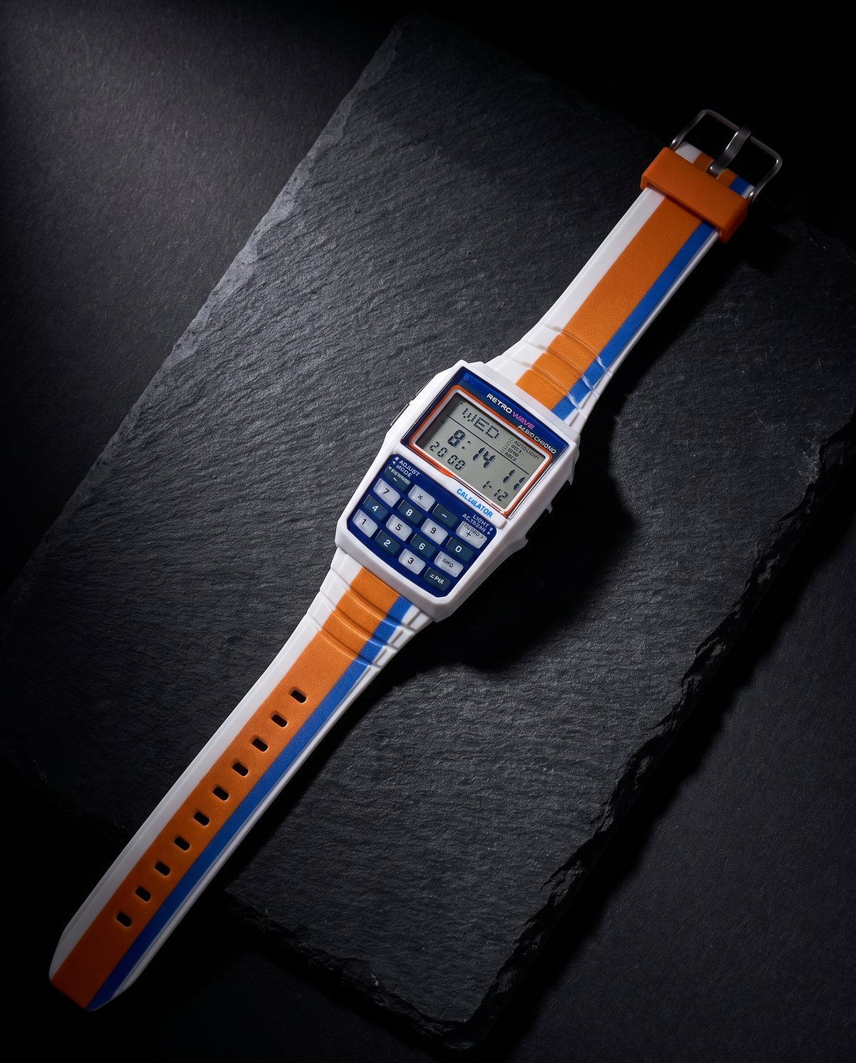 Blue RetroWave calculator watch laid flat on dark stone
